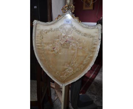 A 19th century painted pole screen, with a silk embroidered panel 
