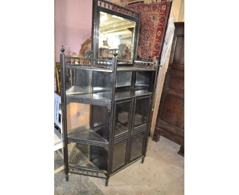 A Victorian Aesthetic period ebonised cabinet, 118 cm wide, lacks a leg, finial loose and present 