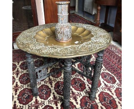 An Indian brass tray, on a folding stand, 77 cm diameter, and a mother of pearl inlaid vase, much loss, 29 cm high (2) 