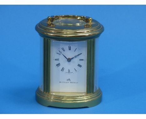 A 20thC gilt-brass oval Carriage Clock, of five-glass form, the white enamel dial with black Roman numerals, signed Matthew N