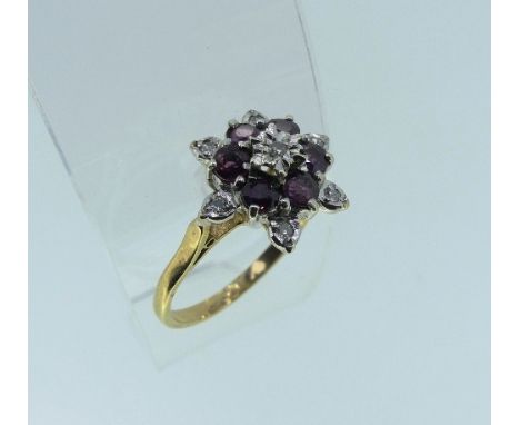A ruby and diamond cluster Ring, mounted in 9ct yellow gold, Size N.
