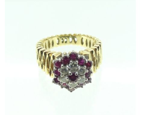 A ruby and diamond Cluster Ring, the central ruby surrounded by six diamonds with an outer surround of twelve rubies, set on 