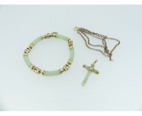 A jade Bracelet, formed of five rounded jade plaques, each set between with  pierced round gold link, marked on the clasp 14k