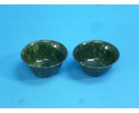 A pair of vintage oriental spinach jade bowls, 4in (10cm) diameter (2)