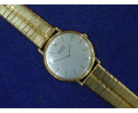 Rolex: A gentleman's 18ct gold Rolex Geneve manual wind wristwatch, the silvered dial with gold baton markers, on 18ct gold f