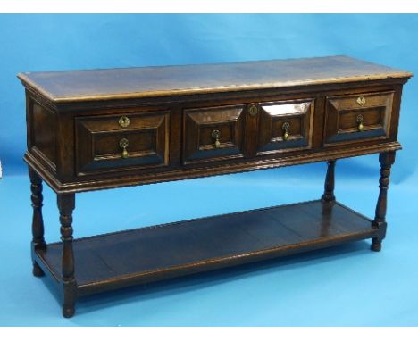 A 19thC oak Carolean Style Dresser, the four frieze drawers with geometric fielded panels and brass drop handles, over a pot 