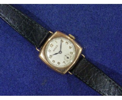 Rolex: a vintage 9ct gold lady's / child's Wristwatch, the cushion case with circular silvered dial, gold Arabic numerals and