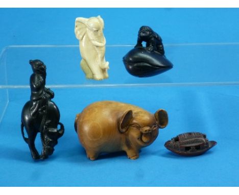 A Japanese wood netsuke, modelled as a figure astride a water buffalo, signed, 2¾in (7cm) high, and another netsuke, modelled