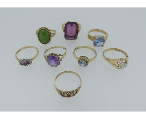 A collection of seven 9ct yellow gold Rings, variously set including three stone garnet, ruby and diamond, facetted amethyst,