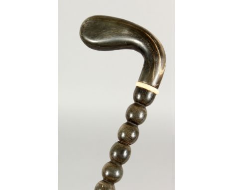 A 19TH CENTURY BOBBIN TURNED WALKING STICK with RHINO HANDLE. 35ins long.