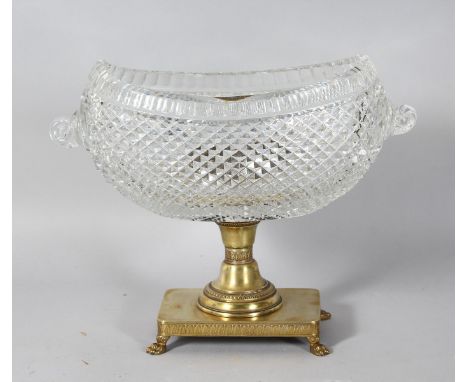 A GOOD HOBNAIL CUT BOAT SHAPED BASIN, with curling handles, on a brass base with claw feet. 9.5ins high.