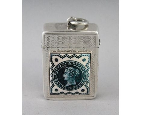 A VICTORIAN ENGRAVED SILVER VESTA CASE, Birmingham 1898, with an enamel half penny stamp.