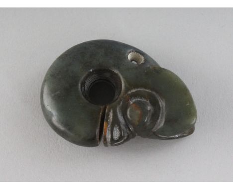 A CARVED JADE AMULET, a "head". 2.25ins.