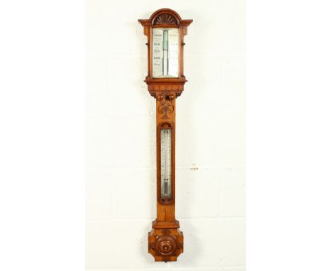 A GOOD VICTORIAN OAK CASED STICK BAROMETER by J. HUGHES, LONDON, with ivory in an architectural case. 39.5ins high.