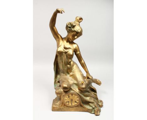 AN ART NOUVEAU GILT SPELTER FIGURAL MANTLE CLOCK, with eight-day movement, the case modelled as a young lady reclining on a r