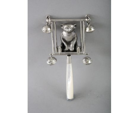 A SILVER AND MOTHER-OF-PEARL TEDDY ON A SWING RATTLE.