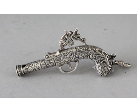 A NOVELTY SILVER GUN WHISTLE. 2.5ins.