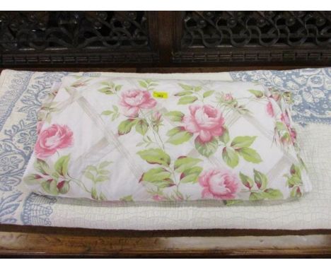 A blue and white eiderdown and a vintage floral bed cover 