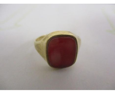 A 9ct gold signet ring set with a red tablet 