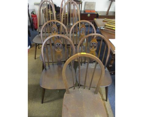 Two sets of four Ercol dark beech, spindle back chairs and another similar 