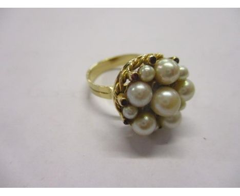 A gold coloured metal ring set with pearls and rubies, 7.75g, stamped 750 