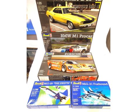 Five plastic kits; Revell 1:24 cars, Porsche 956, BMW m110 1:25 car, 69 Camaro Z 28 and a 1:144 MIG 31 and MIG 29. P&amp;P Gr