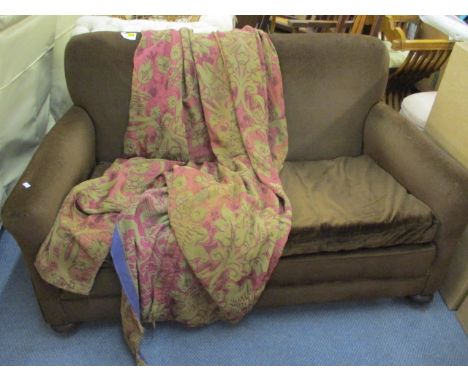 An Archibald Kenrick & Sons, two seater sofa in brown dralon, with loose covers having front oak bolbous feet on castors