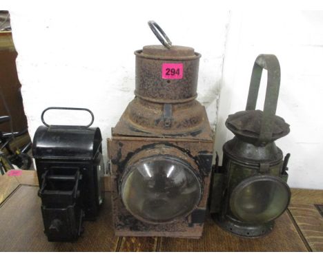 Three metal lamps to include a road roller oil lamp, a railway example with a green and blue lens and another, stamped with a