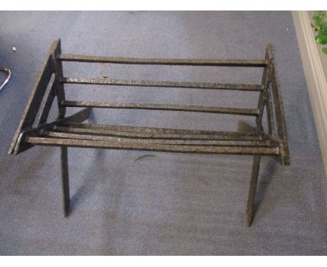 A black painted iron trough with crossover legs