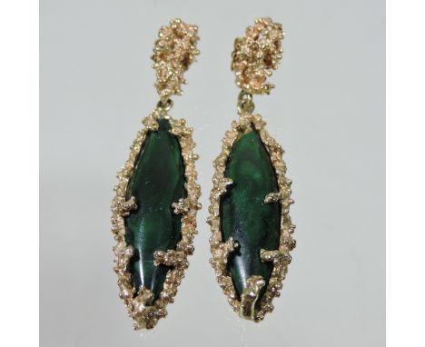 A pair of 14 carat gold and malachite pendant earrings, each suspended with an elliptical polished stone, with a coral design