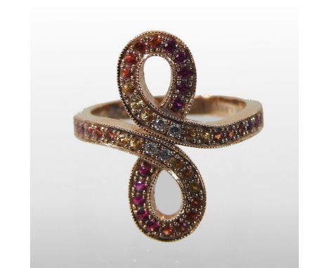 A Lalique 18 carat gold ruby and diamond ring, of crossover design, set with a continuous line of graduated coloured stones, 