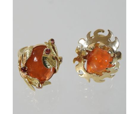 An unmarked cabochon ring, in an openwork leaf surround with collet set gemstones, size N, together with an orange garnet rin