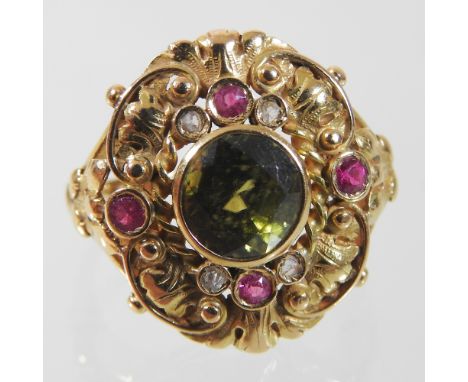 An unmarked peridot, diamond and ruby ring, the central collet set stone, within an ornate filigree surround, size M