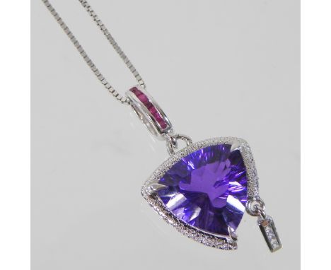 A Camilli 18 carat gold trillion amethyst, ruby and diamond pendant necklace, of triangular shape, within a broken halo surro
