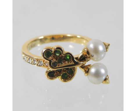 A Dior 18 carat gold, emerald, peridot, pearl and diamond articulated ring, of oak leaf design, suspended with a pair of acor