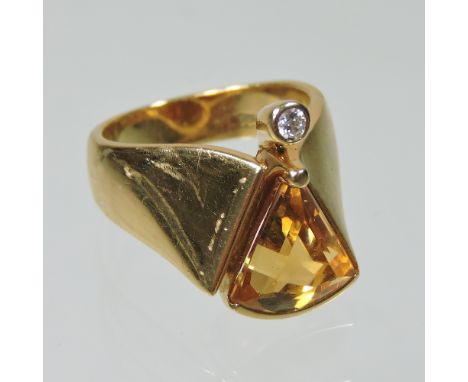 An 18 carat gold citrine and diamond ring, set with a triangular stone, with a collet set diamond below, size K/L, 9.2g gross