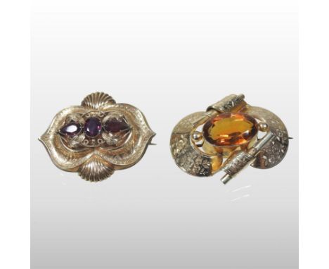 An unmarked citrine brooch, with engraved decoration, in the form of a scroll, 4.5cm, 14.7g gross, together with an ornate 19