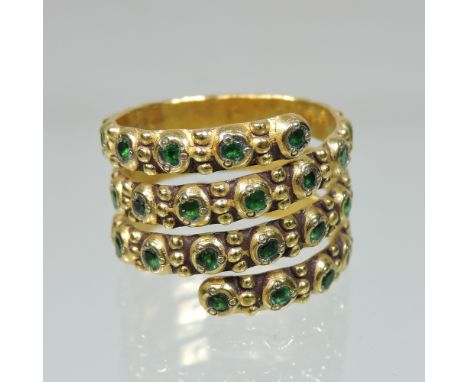 A contemporary 18 carat gold emerald set ring, of spiral design, size N/O, 11.8g gross