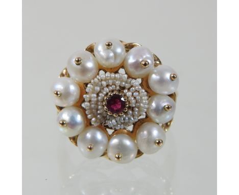 An unmarked ruby, seed pearl and pearl cluster ring, on a rope twist setting, 2cm diameter, size P, 6.4g gross