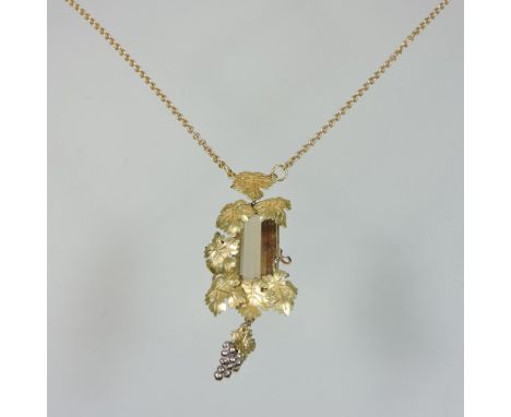 A modern 18 carat gold necklace, set with a baguette cut quartz, with a vine leaf surround, 7cm drop, on a fine 18 carat gold