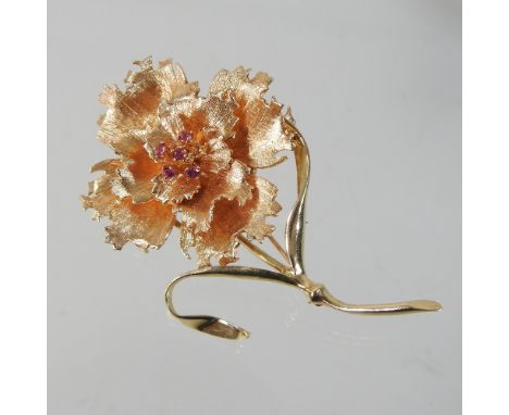 A 14 carat gold and ruby set brooch, in the form of a peony, with a pin back (stone missing), 7cm wide, 21.5g gross