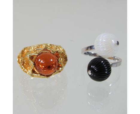 A modern Lalique silver and two colour glass ring, of crossover design, in the form of two opposing black and white glass orb