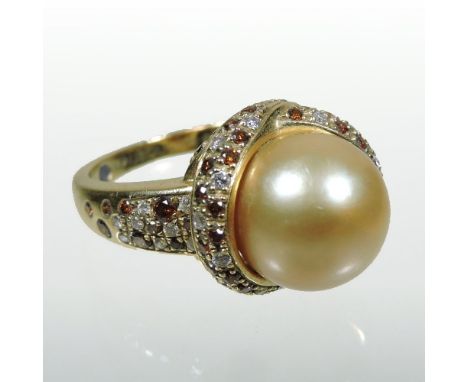 A Mauboussin 18 carat gold and golden pearl ring, crossover set with an alternating diamond and citrine surround and shoulder