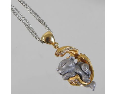 A Magerit Dreams collection 18 carat two colour gold and diamond pendant necklace, in the form of a bear resting in a scrolle