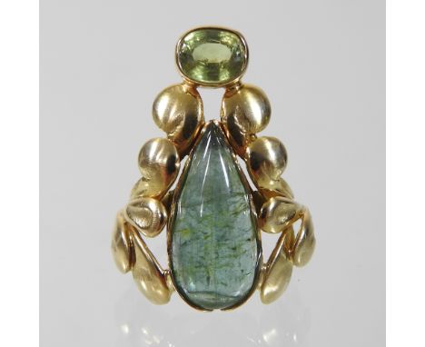 A large unmarked agate and peridot ring, of tapered shaped, with a foliate surround, 3.5cm long, size N, 12.2g gross