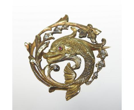 An unmarked Magerit style ruby and diamond set brooch, of circular shape, in the form of a swimming dolphin, 3cm diameter