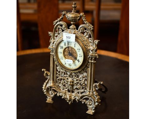 An antique mantel clock with drum movement in ornate Florentine brass strut frame, 32 cm high