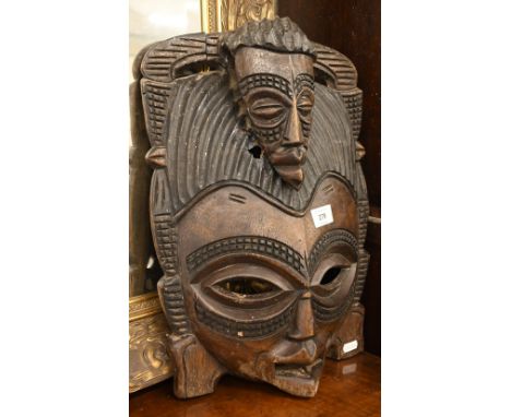 A vintage African tribal carved wood mask, 42 cm h