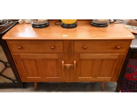A mid-century Ercol elm and beech sideboard with two drawers and panelled cupboards raised on splayed supports, 124 cm w x 46