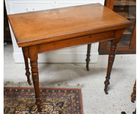 A late 19th century walnut card table, the fold over top raised on turned legs to brass castors, 86 x 49 (98 open) x 74.5 cm 